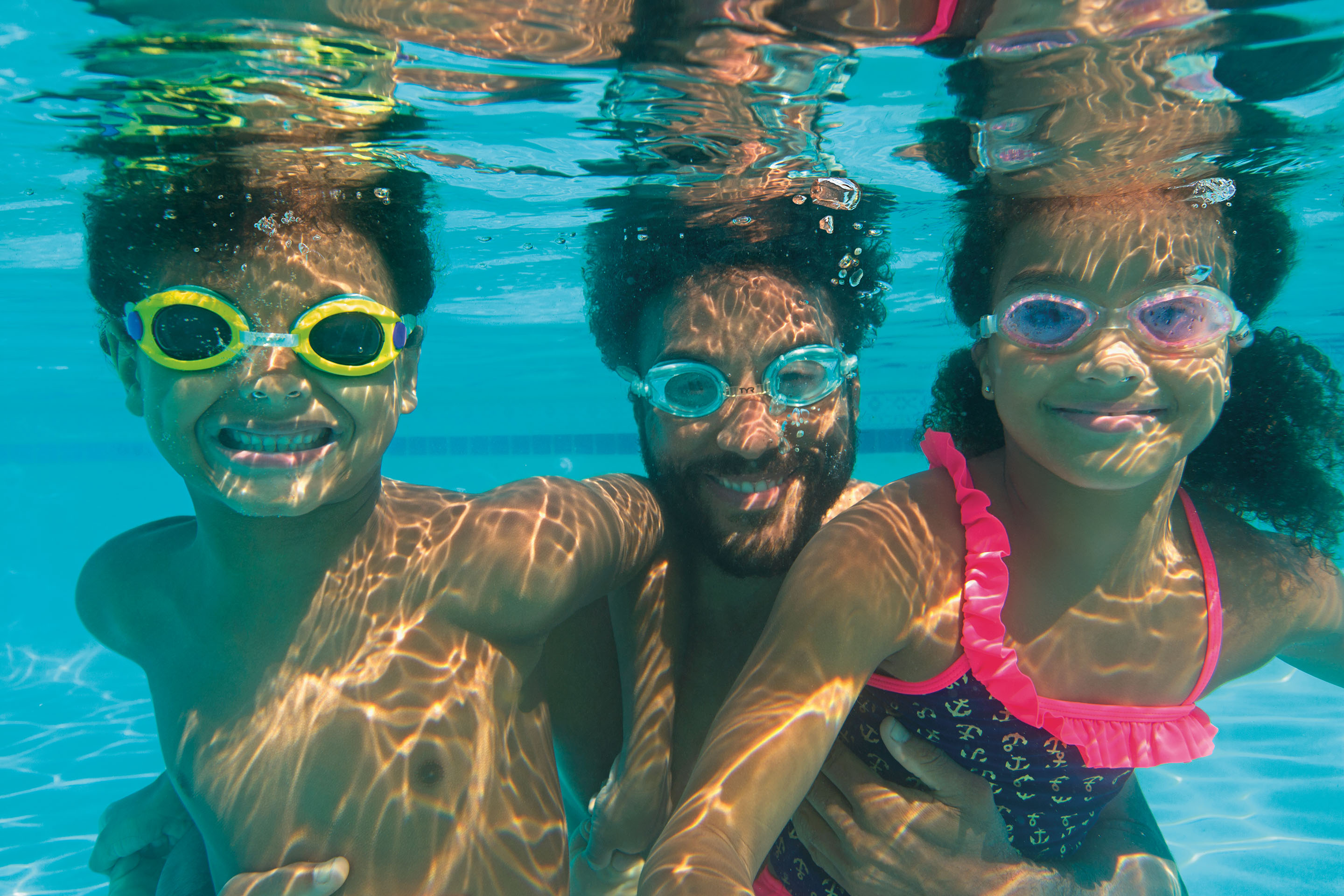 Father with his son and daughter underwater